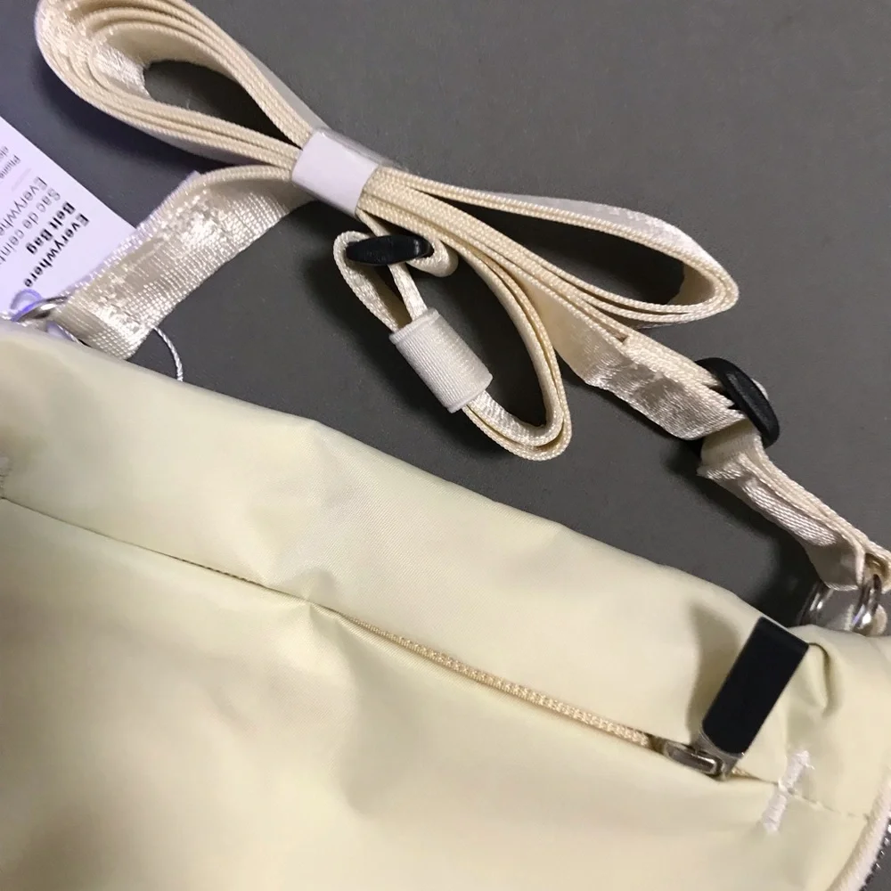 lululemon athletica cream fold-over wristlet with front zip 2L